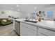 Bright kitchen featuring a marble countertop island with stainless steel dishwasher and a sink at 6144 Rathbone St, Las Vegas, NV 89166
