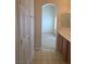 Hall bathroom with double sinks and archway looking into the bedroom at 6461 Za Zu Pitts Ave # 102, Las Vegas, NV 89122