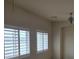 Bright bedroom featuring plantation shutters and a ceiling fan, providing both privacy and comfortable living at 6461 Za Zu Pitts Ave # 102, Las Vegas, NV 89122
