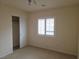 Neutral bedroom features carpet and window with white shutters at 6461 Za Zu Pitts Ave # 102, Las Vegas, NV 89122