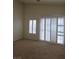 Bright bedroom filled with natural light from large windows and slider to back at 6461 Za Zu Pitts Ave # 102, Las Vegas, NV 89122