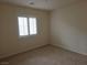 Light-filled bedroom with carpeted floor and modern window shutters at 6461 Za Zu Pitts Ave # 102, Las Vegas, NV 89122