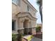 Welcoming two-story townhome entrance featuring a covered porch and number 102, with easy access to the front door at 6461 Za Zu Pitts Ave # 102, Las Vegas, NV 89122