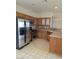 Kitchen with stainless steel appliances, wooden cabinets, and a tile backsplash, offering a functional cooking space at 6461 Za Zu Pitts Ave # 102, Las Vegas, NV 89122