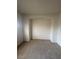 Empty room with neutral carpet, walls, baseboards, and an alcove suitable for a bookcase or decorations at 6461 Za Zu Pitts Ave # 102, Las Vegas, NV 89122