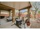 Rear yard featuring a covered patio, outdoor seating, and desert landscaping at 6470 Little Harbor Ct, Las Vegas, NV 89141