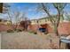 Fenced backyard with desert landscaping, a swing, and comfortable seating area at 6470 Little Harbor Ct, Las Vegas, NV 89141