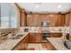 A kitchen with granite counters, stainless steel appliances, and ample cabinet space at 6470 Little Harbor Ct, Las Vegas, NV 89141