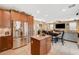 Open-concept kitchen with stainless steel refrigerator and a center island with granite countertop at 6470 Little Harbor Ct, Las Vegas, NV 89141