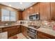 Close up on a kitchen featuring granite countertops, stainless steel appliances, and tile backsplash at 6470 Little Harbor Ct, Las Vegas, NV 89141