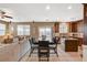 Open-concept living and dining area featuring a neutral color palette and plenty of natural light at 6470 Little Harbor Ct, Las Vegas, NV 89141
