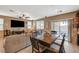 Open living room with tile floors, a ceiling fan, and a sliding glass door to the patio at 6470 Little Harbor Ct, Las Vegas, NV 89141