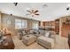Cozy living room featuring tile floors, ample seating, and natural light at 6470 Little Harbor Ct, Las Vegas, NV 89141
