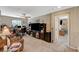 This living room offers ample space with a tv, computer, couch, fan, and access to other rooms at 6470 Little Harbor Ct, Las Vegas, NV 89141