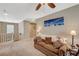 Cozy carpeted loft area featuring a comfortable sofa and decorative accents at 6470 Little Harbor Ct, Las Vegas, NV 89141