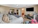 This main bedroom features carpet, neutral walls, a tv, an ensuite bath, and plenty of natural light at 6470 Little Harbor Ct, Las Vegas, NV 89141