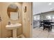 This powder room features a pedestal sink, decorative mirror and convenient access to living/dining area at 6470 Little Harbor Ct, Las Vegas, NV 89141