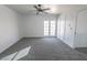 Spacious bedroom featuring modern gray carpeting and neutral paint at 6586 Mount Roy Ln, Las Vegas, NV 89156