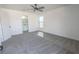 This bedroom features modern gray carpeting, a ceiling fan, and neutral paint at 6586 Mount Roy Ln, Las Vegas, NV 89156