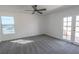 Bright bedroom with updated gray carpeting and modern double doors to backyard at 6586 Mount Roy Ln, Las Vegas, NV 89156