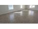Bright and open living area featuring tiled floors and natural lighting at 6586 Mount Roy Ln, Las Vegas, NV 89156