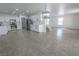 Open-concept living area featuring tile floors, stairs, and modern lighting fixtures at 6586 Mount Roy Ln, Las Vegas, NV 89156
