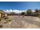 Spacious desert rock backyard with a small storage shed, patio, and space for entertaining at 6751 Stubblefield Dr, Pahrump, NV 89061