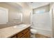 Bathroom with single sink vanity and white tiled shower and tub combination at 6751 Stubblefield Dr, Pahrump, NV 89061