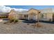 Cozy front entrance featuring low maintenance landscaping, chairs, and covered porch at 6751 Stubblefield Dr, Pahrump, NV 89061