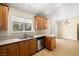 Bright kitchen featuring tile floors, stainless steel appliances, and a window with backyard views at 6751 Stubblefield Dr, Pahrump, NV 89061