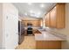 Eat-in kitchen features stainless steel appliances, tile flooring, and lots of natural light at 6751 Stubblefield Dr, Pahrump, NV 89061