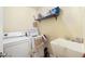 Laundry room with washer, dryer, utility sink, and storage shelf at 6751 Stubblefield Dr, Pahrump, NV 89061