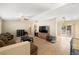 Bright living room with neutral walls, tile flooring, and sliding glass doors to backyard at 6751 Stubblefield Dr, Pahrump, NV 89061