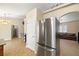 Open-concept living space featuring a stainless steel refrigerator and doorway leading to the living room at 6751 Stubblefield Dr, Pahrump, NV 89061
