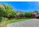 Backyard featuring a stone patio, artificial turf, lush plants, and privacy foliage at 6773 Goose Watch Ct, Las Vegas, NV 89139