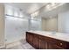 Modern bathroom showcasing double vanity with dark wood cabinets and sleek glass shower at 6773 Goose Watch Ct, Las Vegas, NV 89139