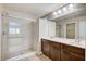 Bathroom featuring a glass shower, double sink vanity, and tile flooring at 6773 Goose Watch Ct, Las Vegas, NV 89139