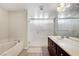 Bright bathroom featuring soaking tub, walk-in shower with glass door, and double vanity at 6773 Goose Watch Ct, Las Vegas, NV 89139
