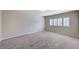 Spacious bedroom featuring neutral carpet and shuttered windows at 6773 Goose Watch Ct, Las Vegas, NV 89139