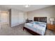 Comfortable carpeted bedroom with a wooden bed frame and natural light, plus desk at 6773 Goose Watch Ct, Las Vegas, NV 89139