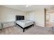 Bedroom with carpet, queen-sized bed with black headboard, nightstand, and desk at 6773 Goose Watch Ct, Las Vegas, NV 89139