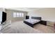 Spacious bedroom featuring large window, neutral carpet, and minimal contemporary decor at 6773 Goose Watch Ct, Las Vegas, NV 89139