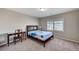 Bedroom with carpet, desk, chair, and full-sized bed at 6773 Goose Watch Ct, Las Vegas, NV 89139