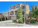 Beautiful two-story house with balcony, stone accents, and a three-car garage with mature landscaping at 6773 Goose Watch Ct, Las Vegas, NV 89139