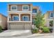 Charming two-story home with stone accents, balcony, three-car garage, and landscaped front yard at 6773 Goose Watch Ct, Las Vegas, NV 89139