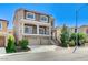 Inviting two-story house with stone accents, balcony, three-car garage, and well-maintained lawn at 6773 Goose Watch Ct, Las Vegas, NV 89139