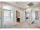 Bright hallway with carpet flooring and doorways leading to bathroom and bedrooms at 6773 Goose Watch Ct, Las Vegas, NV 89139