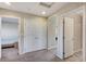 View of the carpeted hallway with doors, closets, and access to other rooms at 6773 Goose Watch Ct, Las Vegas, NV 89139