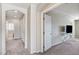 Neutral-toned hallway leads to bedroom, creating a cohesive and bright transitional space at 6773 Goose Watch Ct, Las Vegas, NV 89139