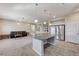 Open-concept kitchen features a large island with granite countertops and modern appliances, flowing into a spacious living area at 6773 Goose Watch Ct, Las Vegas, NV 89139